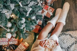 overhead shot of a christmas moment young woman in a cozy sweater sitting by a christmas tree woman t20 pR3p6j
